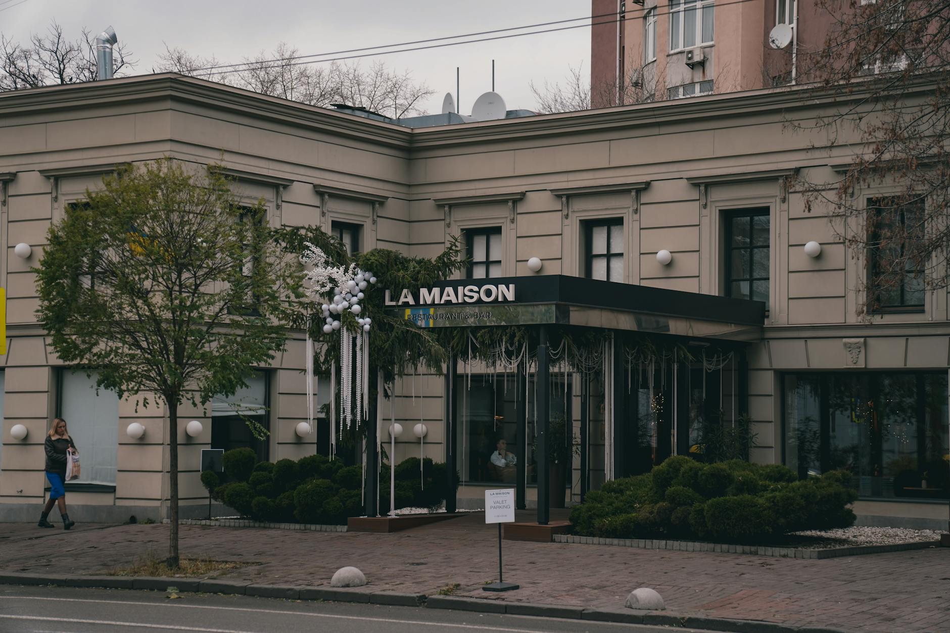 Street view of La Maison restaurant with decorations in Kyiv, Ukraine during early winter.