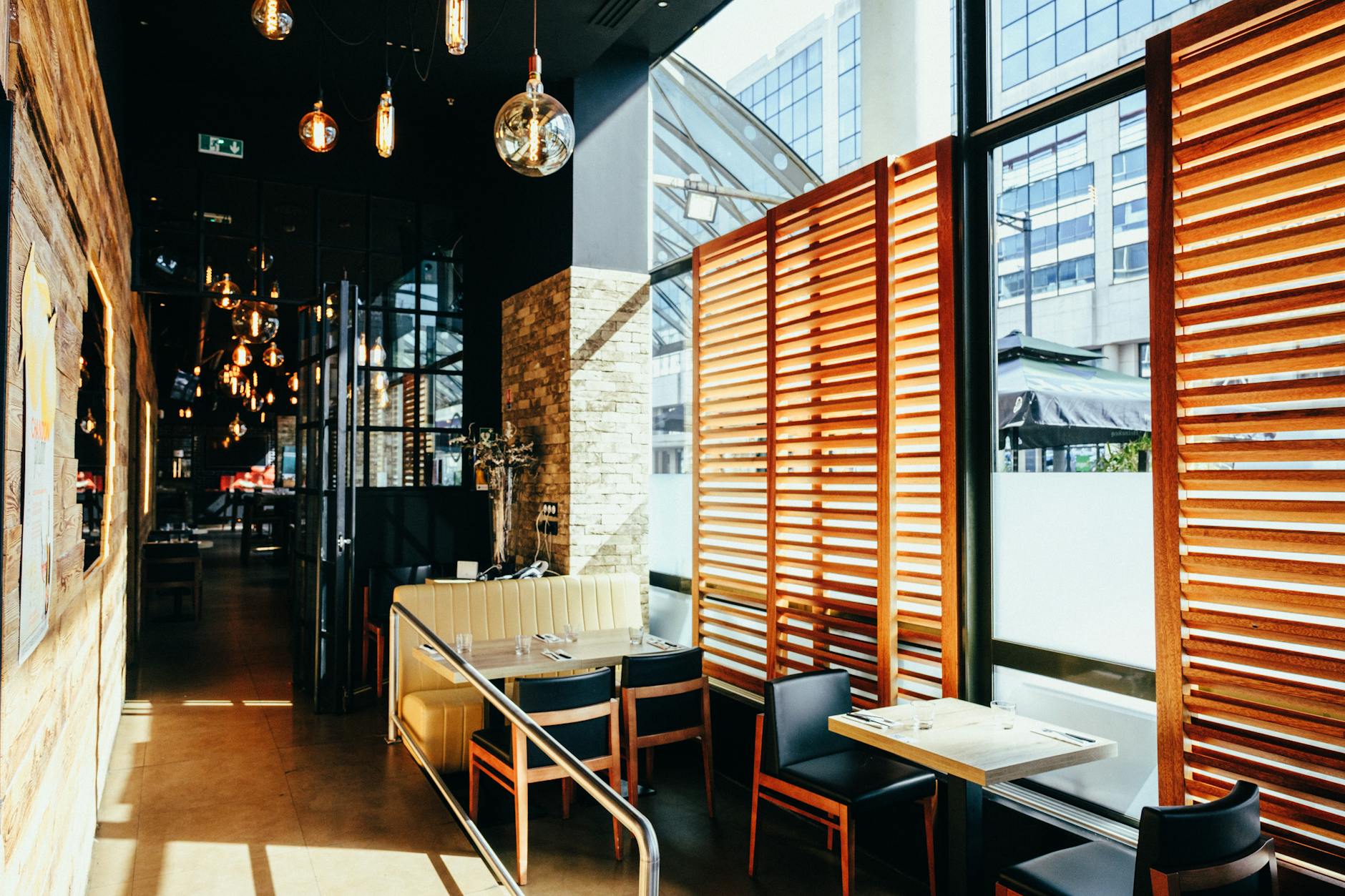 Sunlit cafe interior with contemporary design and cozy ambiance, perfect for a relaxing dining experience.