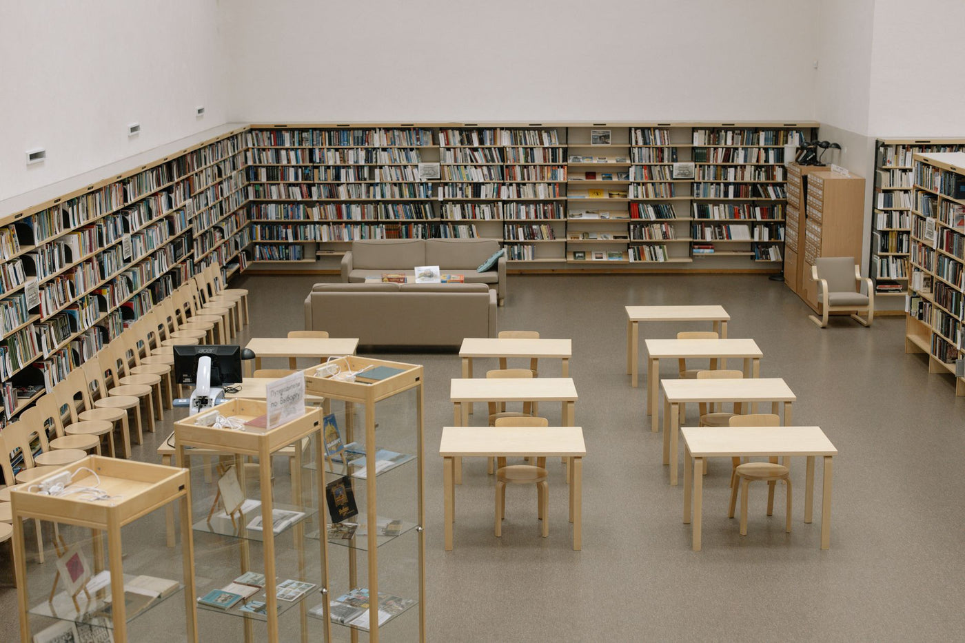 A serene library with bookshelves and wooden furniture, ideal for reading and study.