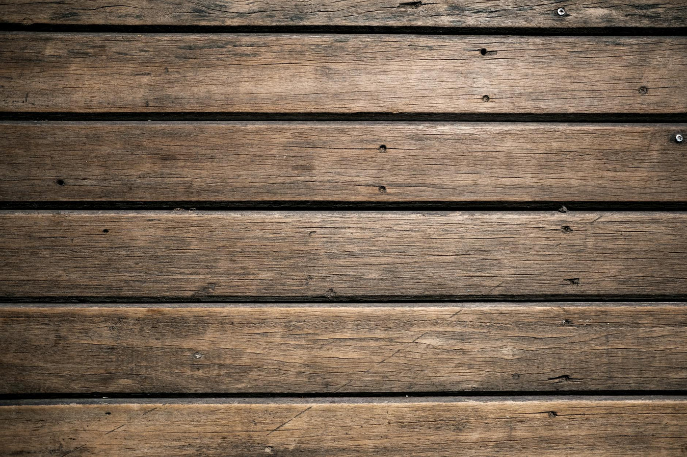 Close-up of aged wooden planks with rustic texture for background or design.