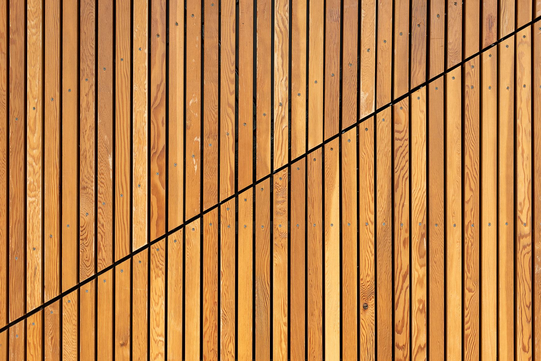 A close-up of wooden slats creating a modern diagonal pattern, ideal for backgrounds.